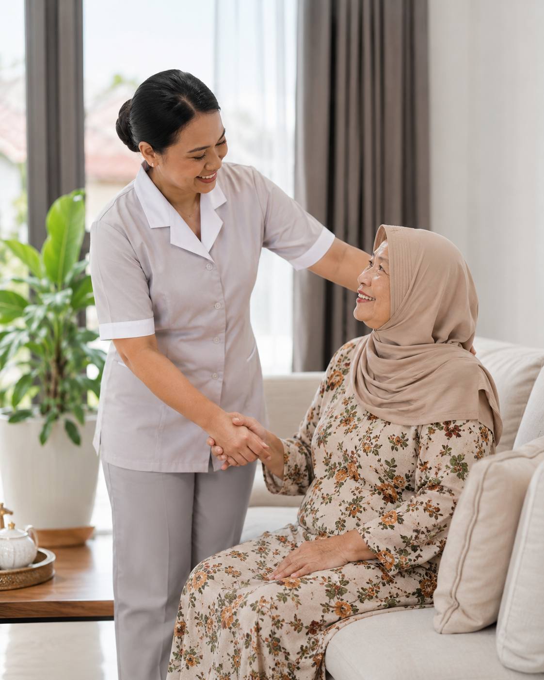 A uniformed domestic helper caring for an elderly woman at home