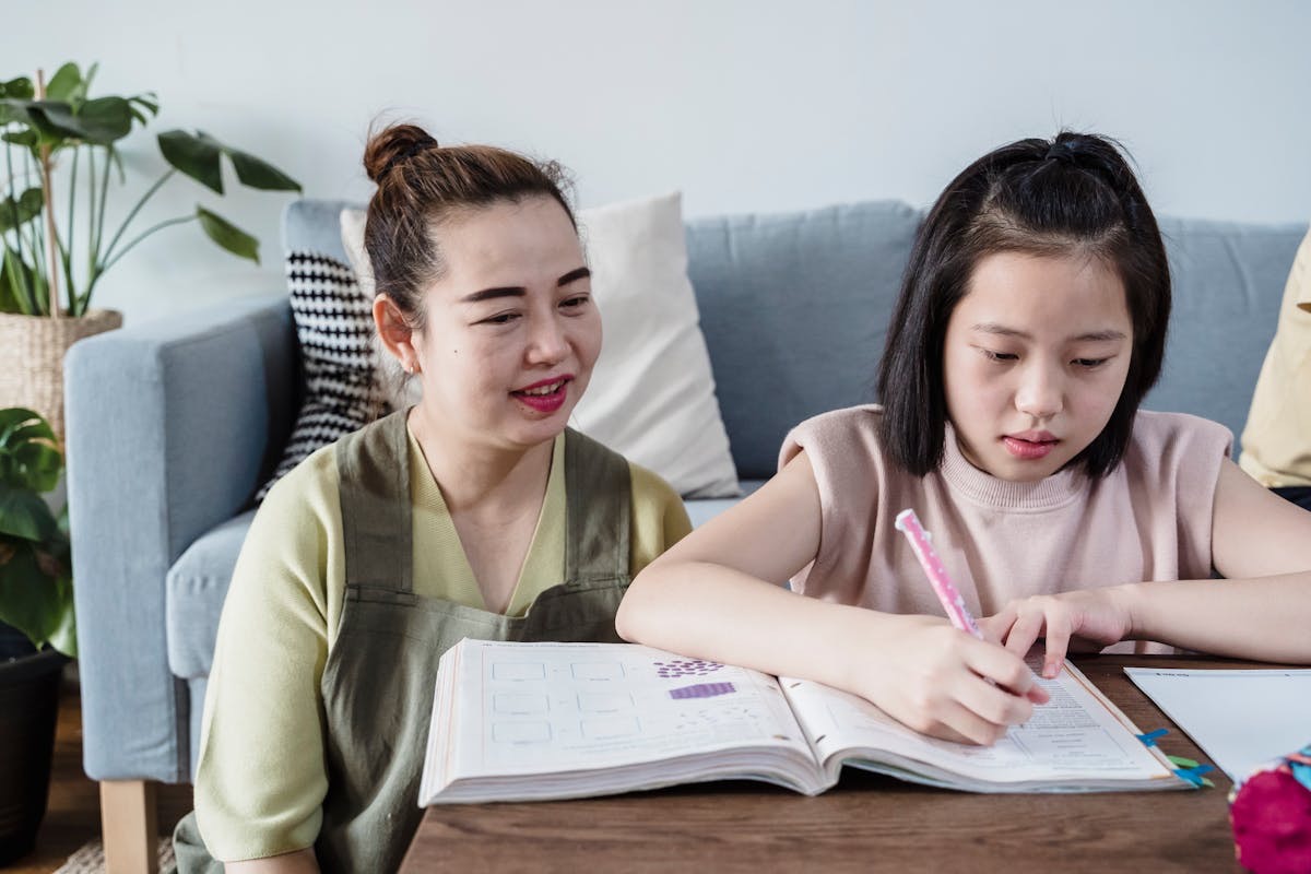 A helper guiding a child through learning at home